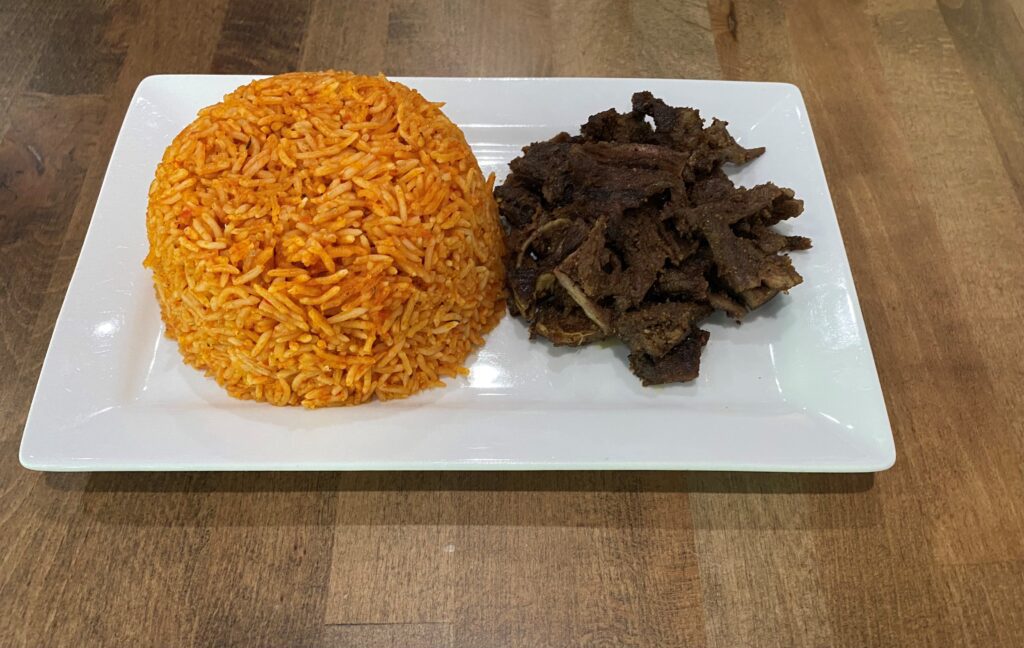 Jollof rice with sliced grilled beef