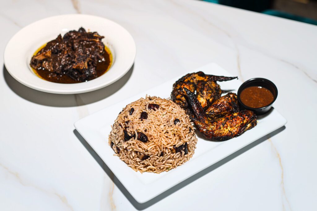 Grilled chicken halves with rice, sauce, and stew