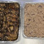 Trays of jerk chicken with rice and peas