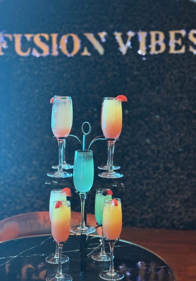 Colorful cocktail flutes on tiered stand